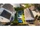 Aerial view showcasing the backyard oasis with a pool, outdoor kitchen, and entertaining area at 7165 Cordery Rd, Cumming, GA 30040
