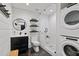 Modern bathroom featuring a glass shower, floating shelves, stackable washer/dryer, and sleek fixtures at 7165 Cordery Rd, Cumming, GA 30040