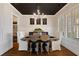 Bright dining room boasts a modern chandelier, dark ceiling, and wood floors at 7165 Cordery Rd, Cumming, GA 30040