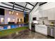 Modern kitchen opens to a backyard pool, featuring white cabinets, stainless appliances and glass door at 7165 Cordery Rd, Cumming, GA 30040