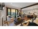 Open-concept living room with fireplace, access to outdoor pool and kitchen views at 7165 Cordery Rd, Cumming, GA 30040
