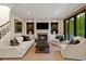 Cozy living room with fireplace, large windows, and comfortable seating at 7165 Cordery Rd, Cumming, GA 30040