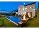 Evening shot of the backyard pool and patio with integrated fire bowls and cozy outdoor seating area at 7165 Cordery Rd, Cumming, GA 30040