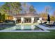 Backyard features an in-ground pool, patio area and an outdoor seating area at 7165 Cordery Rd, Cumming, GA 30040