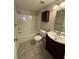 Bathroom featuring a shower over tub, dark wood vanity, and tiled flooring at 1098 Westfield Se Trce, Smyrna, GA 30082