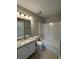 Bathroom featuring a shower over tub with granite countertop and modern fixtures at 1098 Westfield Se Trce, Smyrna, GA 30082