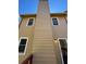 Well-maintained exterior featuring light brown siding, contrasting white trim, and a tall chimney at 1098 Westfield Se Trce, Smyrna, GA 30082
