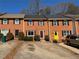 Brick townhomes featuring driveways and lush landscaping, creating a welcoming neighborhood setting at 1098 Westfield Se Trce, Smyrna, GA 30082