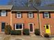 Charming brick townhome featuring a well-maintained front yard and classic architectural details at 1098 Westfield Se Trce, Smyrna, GA 30082