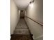 Carpeted stairway with wooden handrail and overhead lighting leading to the next level at 1098 Westfield Se Trce, Smyrna, GA 30082