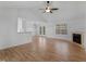 Spacious open-concept living area with hardwood floors and a fireplace at 135 Kimbell Farm Dr, Locust Grove, GA 30248