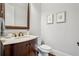 Classic powder room featuring dark wood vanity cabinet with a marble countertop at 1781 Greystone Ct, Marietta, GA 30068