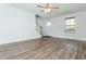 Spacious living room with wood flooring, large windows for natural light, and an open staircase at 2980 Lemans St, Cumming, GA 30041