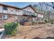 Charming two-story brick building featuring a staircase to upper-level patios and mature landscaping at 1229 Church St # C, Decatur, GA 30030