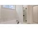 Bright bathroom features a soaking tub, glass enclosed shower, and modern fixtures at 148 Henley St, Canton, GA 30114