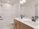 Bright bathroom with double sinks, modern fixtures, and a shower tub combo at 148 Henley St, Canton, GA 30114