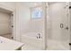 Bright bathroom features a soaking tub, glass enclosed shower, and modern fixtures at 148 Henley St, Canton, GA 30114