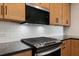 Modern kitchen featuring stainless steel appliances, dark countertops, and subway tile backsplash at 148 Henley St, Canton, GA 30114