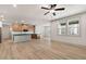 Open-concept living room with wood-look floors and a view of the kitchen at 148 Henley St, Canton, GA 30114