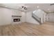 Living room with a marble fireplace, staircase, hardwood floors, and ample natural light at 148 Henley St, Canton, GA 30114