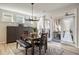 A dining room features a wood table, stylish light fixture, and a door leading to an outdoor porch at 23 Knollwood Nw Way, Cartersville, GA 30121