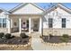 Close-up of the home's inviting front porch with bench and decorative details at 23 Knollwood Nw Way, Cartersville, GA 30121