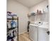 A functional laundry room with modern washer and dryer units and convenient shelving for storage at 23 Knollwood Nw Way, Cartersville, GA 30121