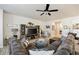 A living room featuring a large sectional sofa, entertainment center, ceiling fan and hardwood floors at 23 Knollwood Nw Way, Cartersville, GA 30121