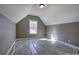 Attic bedroom with natural light from a window, creating a cozy and inviting atmosphere at 30 Grand Georgian Ne Ct, Cartersville, GA 30121