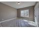 Bright bedroom with a window and neutral walls, ready for personalization and comfort at 30 Grand Georgian Ne Ct, Cartersville, GA 30121