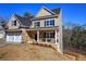 Beautiful two-story house with a stone facade, two-car garage, and a cozy front porch at 30 Grand Georgian Ne Ct, Cartersville, GA 30121