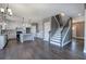 Modern white kitchen with hardwood floors, granite countertops, an island, and stainless steel appliances at 30 Grand Georgian Ne Ct, Cartersville, GA 30121