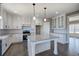 Bright kitchen with granite countertops, white cabinets, an island, and stainless steel appliances at 30 Grand Georgian Ne Ct, Cartersville, GA 30121