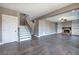 Spacious living room featuring hardwood floors, a fireplace, built-in shelves, and a staircase at 30 Grand Georgian Ne Ct, Cartersville, GA 30121