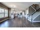 Open-concept living room featuring hardwood floors, staircase, and a view into the modern white kitchen at 30 Grand Georgian Ne Ct, Cartersville, GA 30121