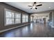 Open-concept living room featuring hardwood floors, large windows, and a view into the modern white kitchen at 30 Grand Georgian Ne Ct, Cartersville, GA 30121