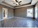 Main bedroom featuring tray ceiling, ceiling fan, carpet and ensuite bath access at 30 Grand Georgian Ne Ct, Cartersville, GA 30121