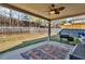 Cozy covered patio with outdoor rug, grill and ceiling fan, perfect for relaxing at 4869 Locherby Dr, Fairburn, GA 30213