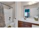 Bathroom featuring a shower with a marble curtain, a single sink vanity and white cabinets at 4869 Locherby Dr, Fairburn, GA 30213