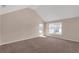 Bright bedroom featuring a vaulted ceiling and natural light from two large windows at 4869 Locherby Dr, Fairburn, GA 30213