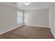 Simple bedroom featuring neutral tones and a large window providing ample natural light at 4869 Locherby Dr, Fairburn, GA 30213