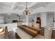 Open-concept dining area with coffered ceilings and stylish chandelier adjacent to the living room at 4869 Locherby Dr, Fairburn, GA 30213