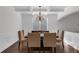 Formal dining room featuring hardwood floors, elegant wainscoting, and a chandelier at 4869 Locherby Dr, Fairburn, GA 30213