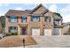 Attractive two-story brick home featuring a three-car garage, manicured lawn, and traditional curb appeal at 4869 Locherby Dr, Fairburn, GA 30213