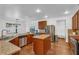 Well-lit kitchen featuring a stainless steel refrigerator and stone countertops at 4869 Locherby Dr, Fairburn, GA 30213