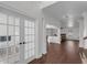 Elegant living room with hardwood floors, white trim, and French doors leading to the office at 4869 Locherby Dr, Fairburn, GA 30213