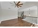 Upstairs loft area with hardwood floors, railing, and modern ceiling fan at 4869 Locherby Dr, Fairburn, GA 30213