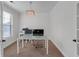 Bright office space with a glass top desk, modern light fixture, and neutral carpet at 4869 Locherby Dr, Fairburn, GA 30213