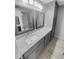 This bathroom features granite countertops, gray cabinets, and a gray-tiled floor at 1950 S Inlet, Marietta, GA 30066