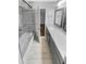 This bathroom offers gray cabinets, granite counters, and a glass-enclosed tub at 1950 S Inlet, Marietta, GA 30066